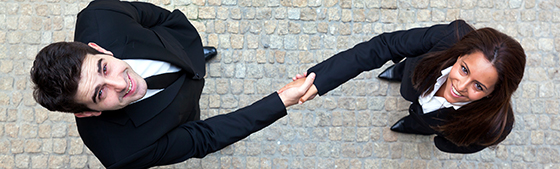 Business handshake between businessman and businesswoman